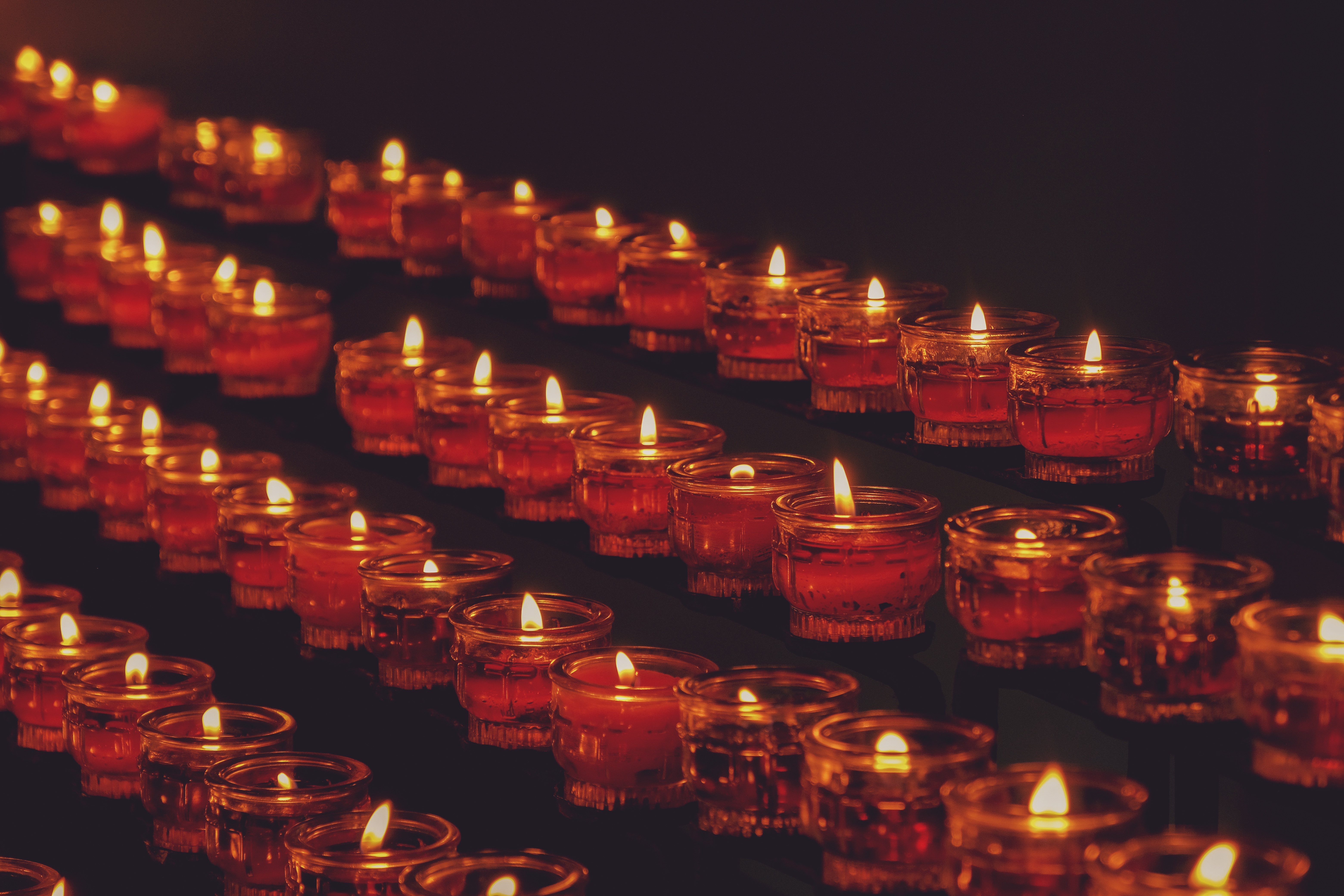 lit tealight candles in rows, angled from the top left corner to the bottom right corner