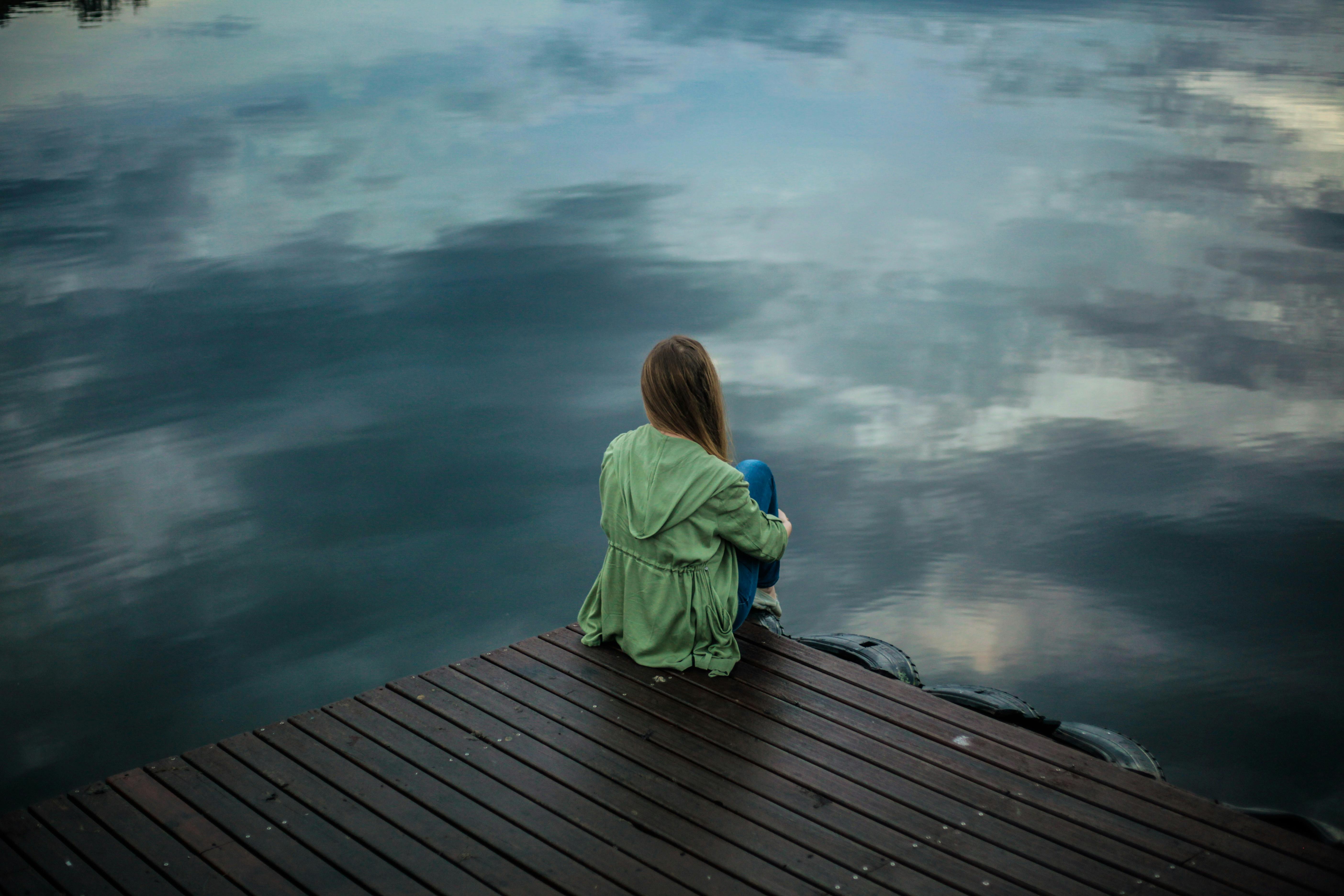 anxiety in the form of a girl pensively looking into water