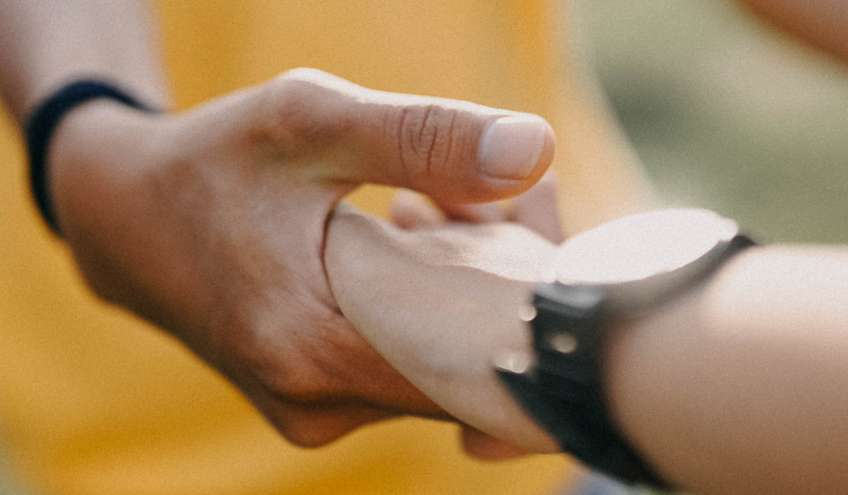 Two people holding hands